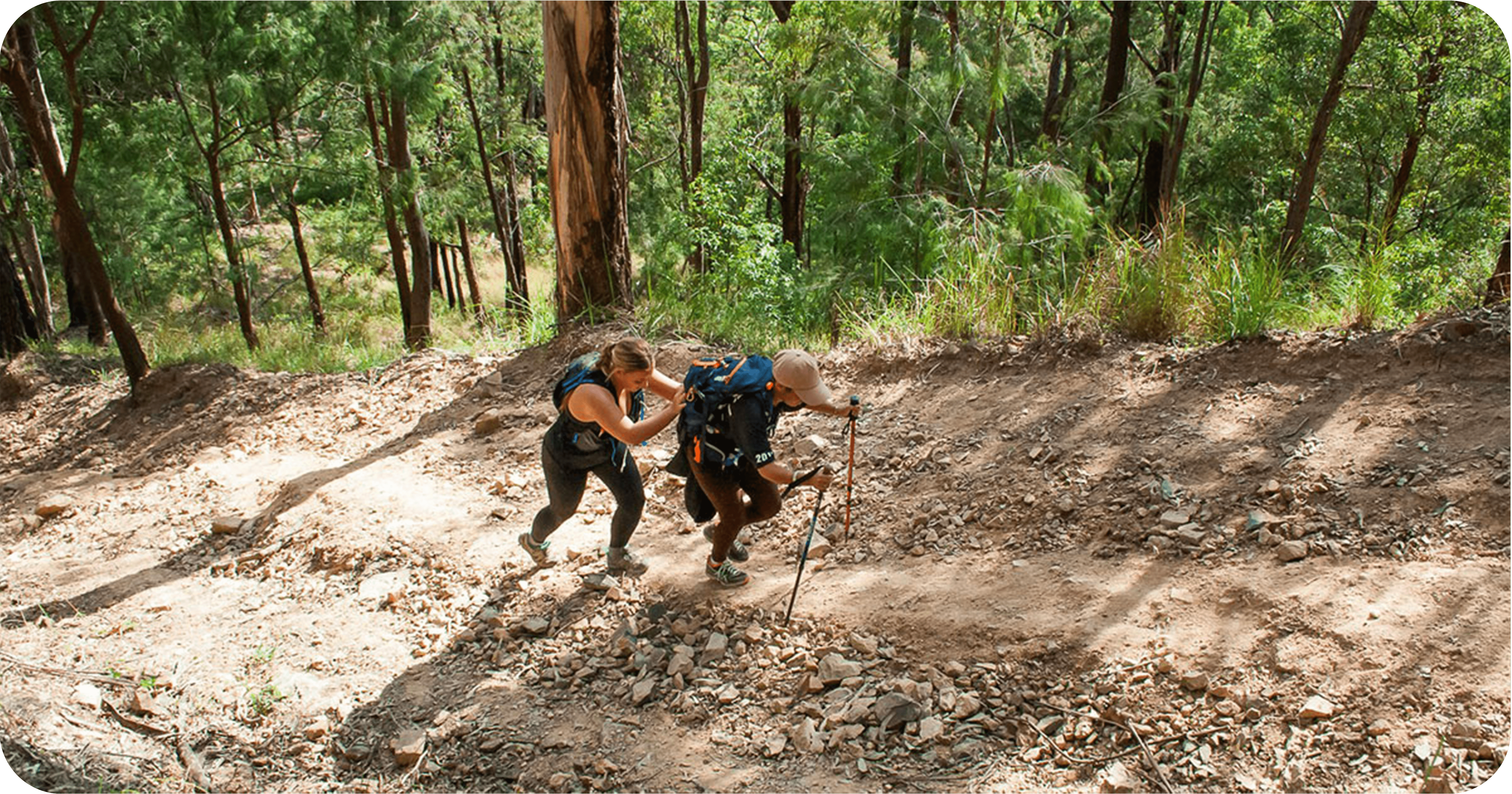 One Kokoda Challenge competitor pushing another participant up a hill in the Gold Coast course One Kokoda Challenge competitor pushing another participant up a hill in the Gold Coast course