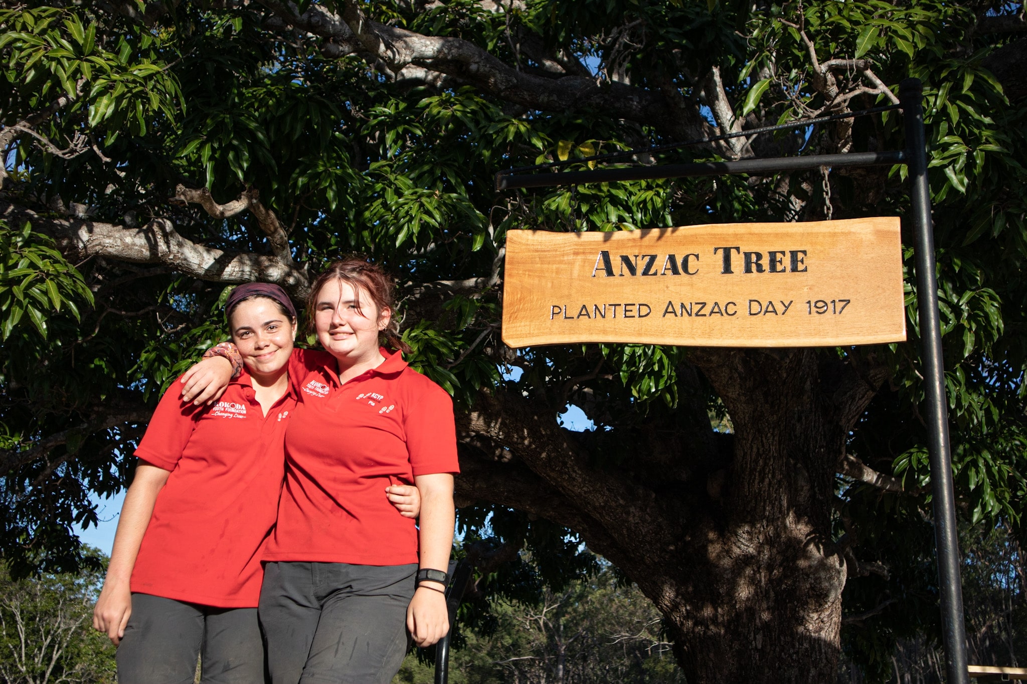 Kokoda Kids standing in front of the ANZAC Tree in Watsonville, Far North Queensland